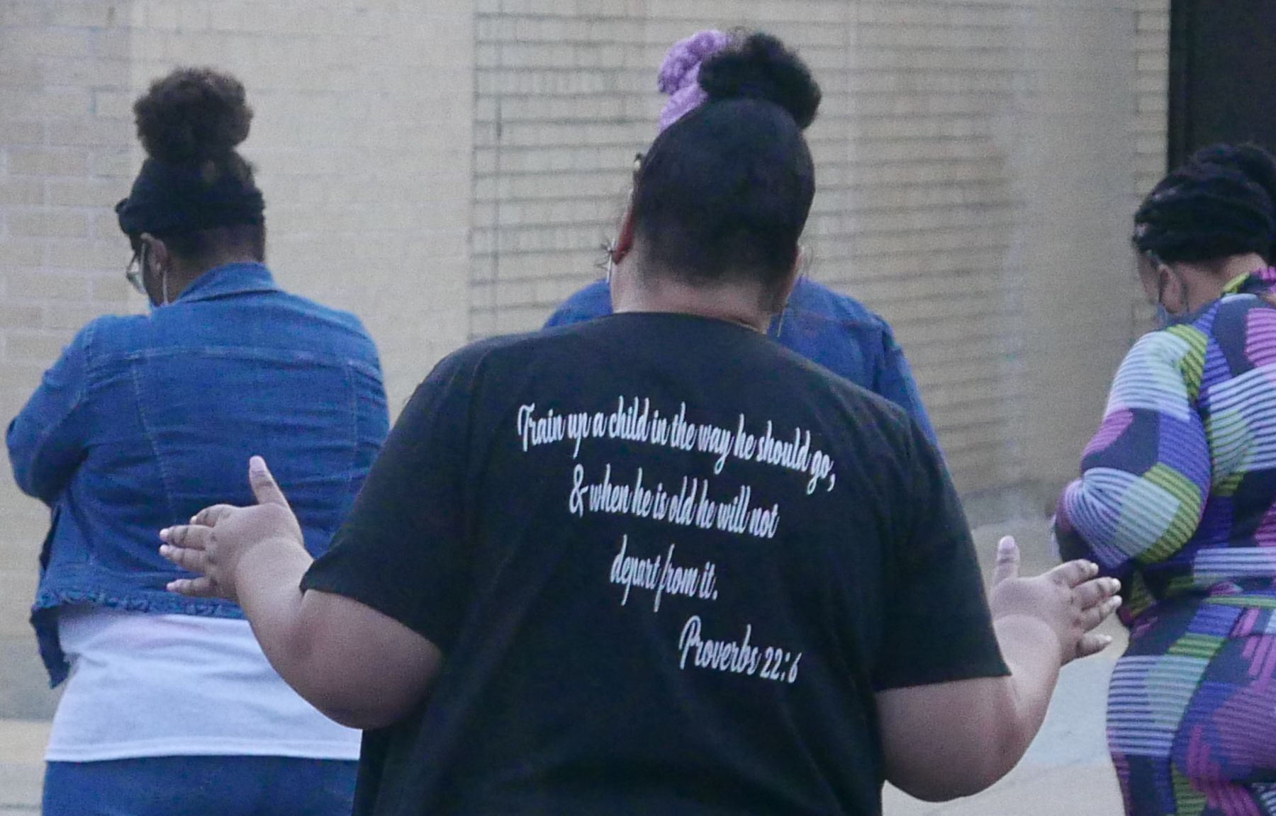 Tanya Wooden joins in prayer at the vigil held Thursday to address gun violence